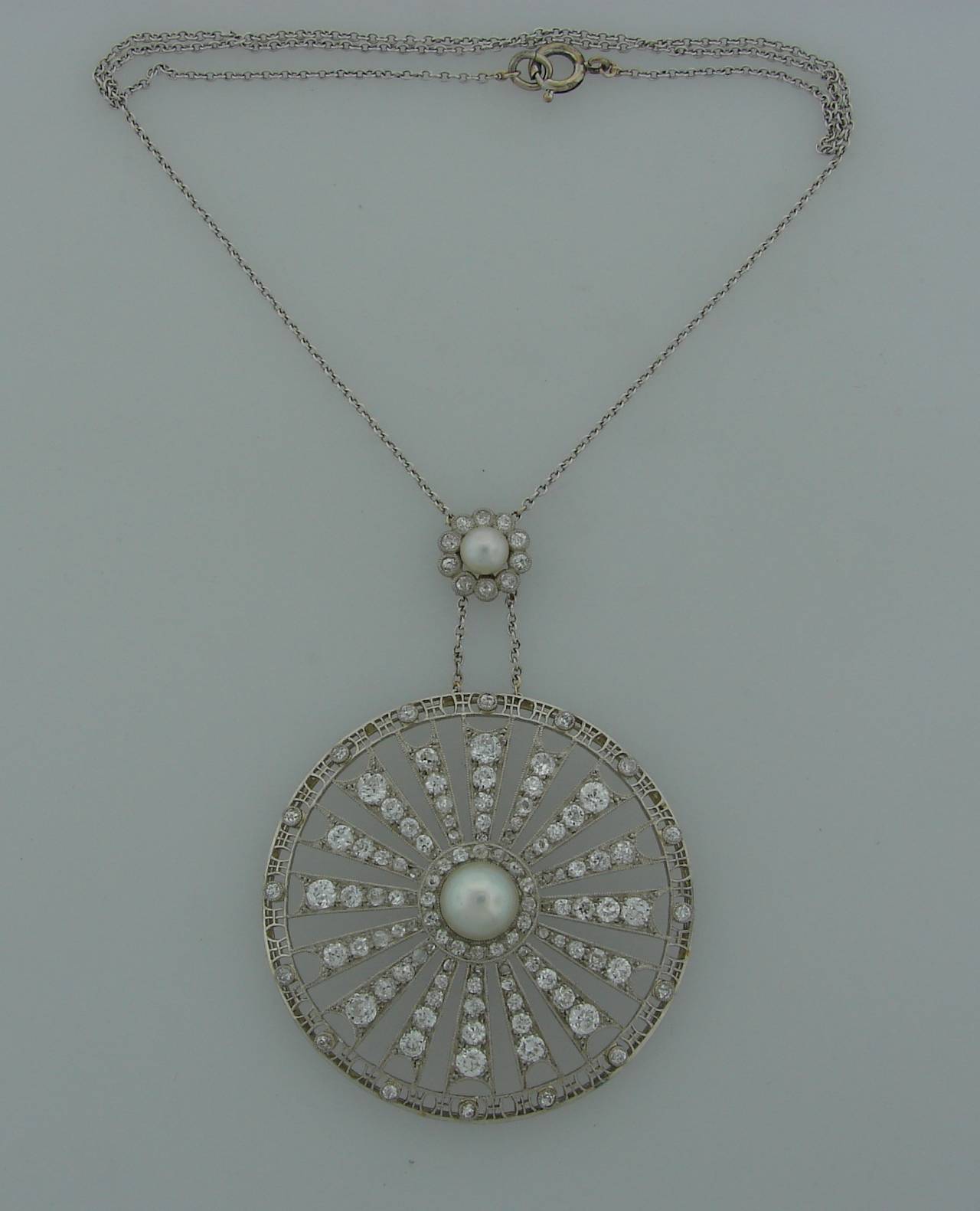 Gorgeous Edwardian circle pendant. Made of platinum, features two natural pearls and Old European cut diamonds. 

Diameter 2
