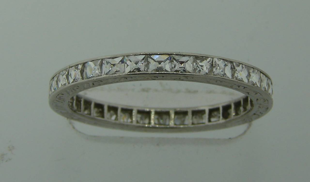 Exquisite Art Deco platinum band set with thirty three French cut diamonds. Nice filigree on platinum. Beautiful Finest French cut diamonds approximately 0.07 carat each, total weight 2.31 carats (G color, VS1 clarity).
The band is size 7.
It is