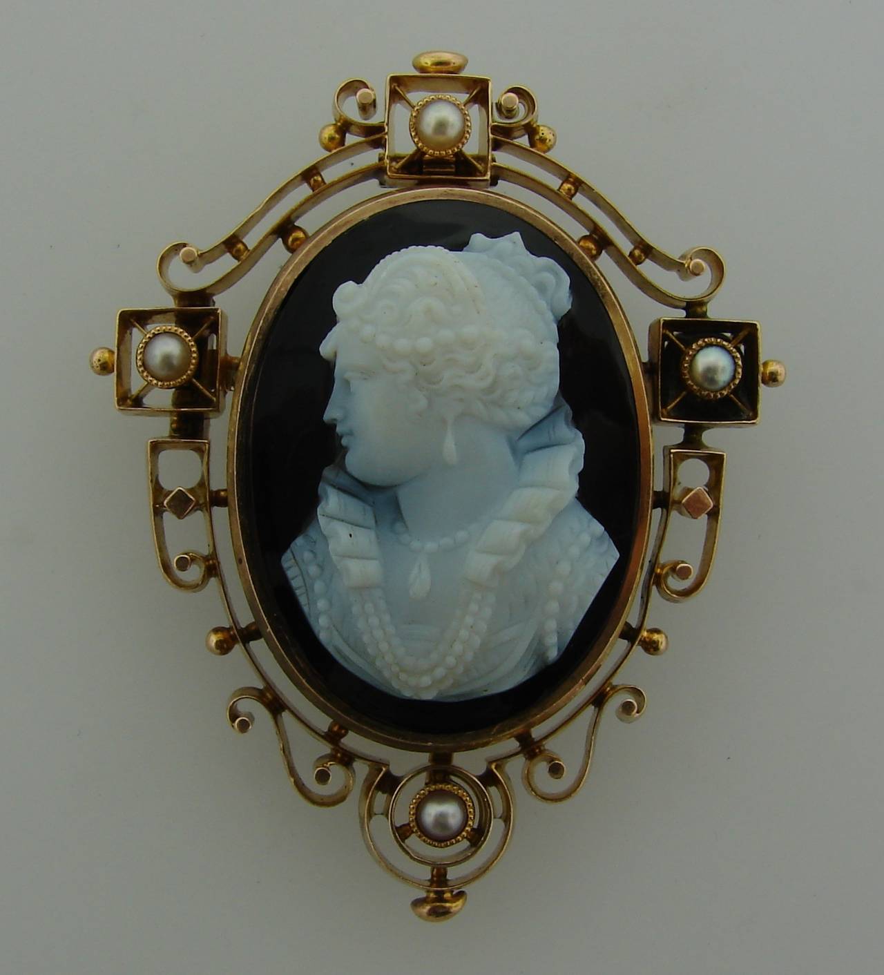 Lovely Victorian cameo pin/pendant with beautiful woman bust carved on agate. The cameo is framed in 14k (tested) yellow gold and accented with four pearls.
The cameo measures 1-1/8