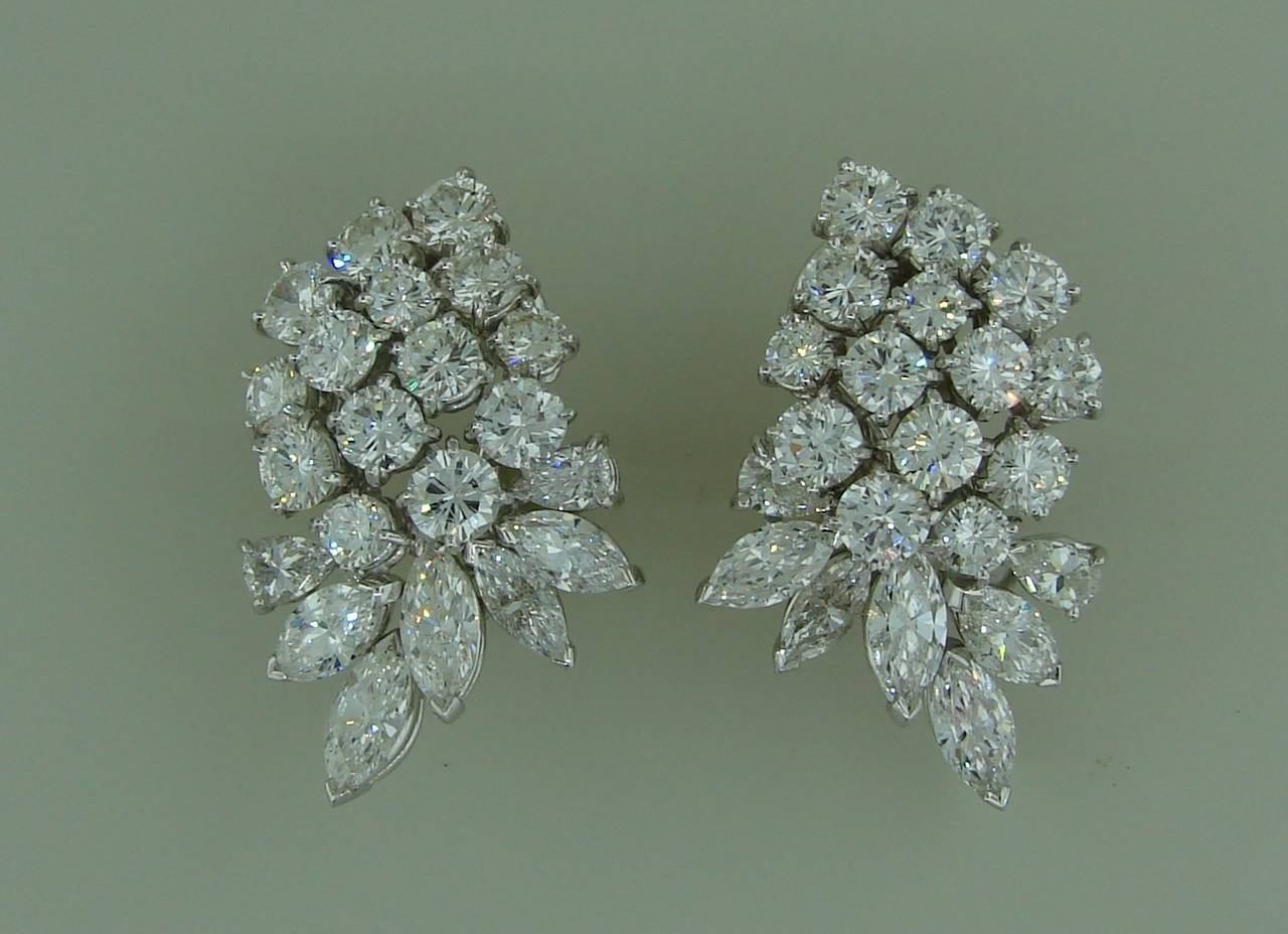 Chic and feminine cluster earrings. They are made of platinum and set with round brilliant, pear-shape and marquise cut diamonds.
28 round brilliant cut diamonds - total weight approximately 7.50 carats
4 pear shape diamonds - total weight