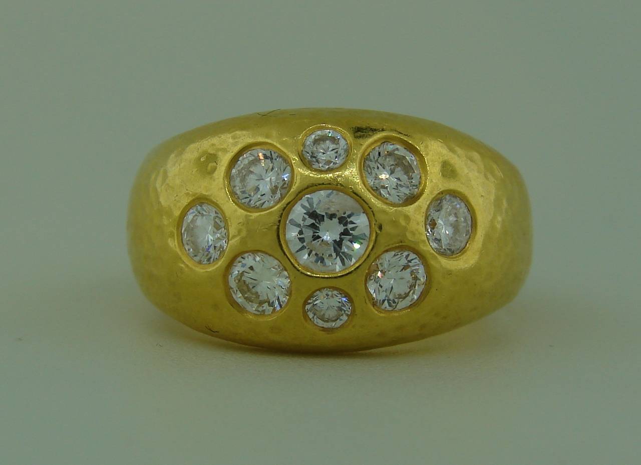 Bold yet elegant ring created by Darlene de Sedle. Beautiful heavy hand-hammered 22k yellow gold shank is set with nine round brilliant cut diamonds - total weight approximately 1.54 carats. The ring is size 7.