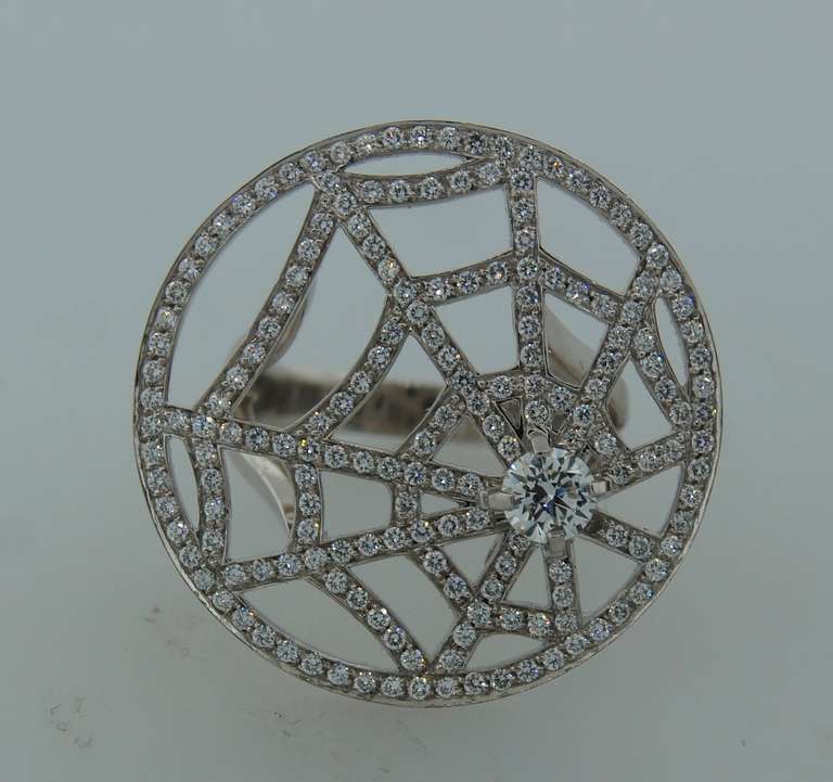 Chic and mysterious cocktail ring created by Chaumet in Paris. Designed as a spider net. Beautiful lines and perfect proportions - definitely a conversational piece!
Made of white gold and studded with diamonds. Center diamond is 0.35-ct. The
