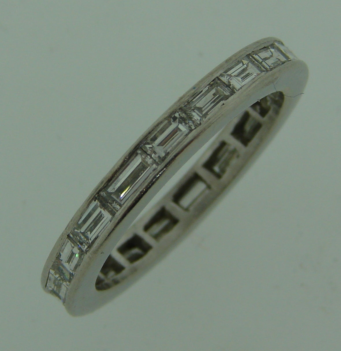 Timeless elegant eternity band. Made of platinum and set with nineteen baguette cut diamonds (H color, VS1-VS2 clarity), total weight approximately 1.90 carats. 
The band is 2.75 mm wide and 2.28 mm thick. It is size 5.75-6.