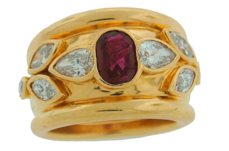 Bold and chic ring created by Verdura in the 1970s. Features an oval ruby set in yellow gold and accented with diamonds. Nice and heavy. Three-dimensional. 
The diamonds are marquise and pear-shape, approximate total weight 2.20 carats. The ruby is