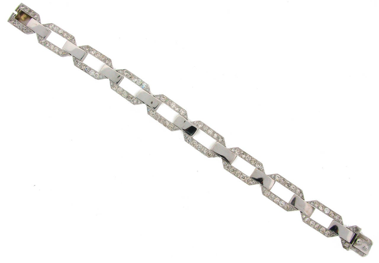 Chic diamond link bracelet created in the 1920's. Old European cut diamonds (H-I color, VS-SI2 clarity) are set in platinum, total weight approximately 7.76 carats. The diamond links are connected with 18k white gold links. There is a nice filigree