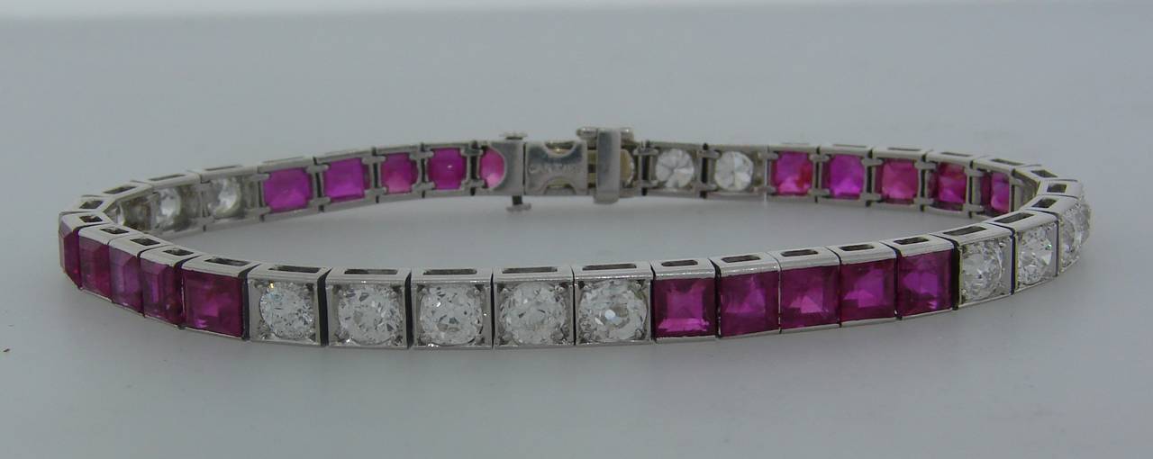 Classy and timeless tennis bracelet created by Cartier in the 1920's. It is made of platinum and set with eighteen Old European cut diamonds and twenty table cut natural rubies. The diamonds are G-H color, VS clarity, total weight approximately 5.07