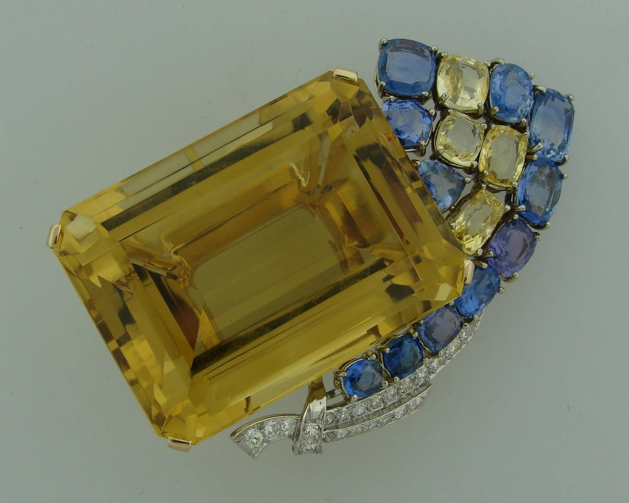 Very impressive Retro brooch created by Seaman Schepps in the 1940's. 

Features a 223.50-carat golden hue citrine accentuated with multi-color sapphires and diamonds. Fifteen natural cushion cut yellow, purple and blue sapphires - total weight