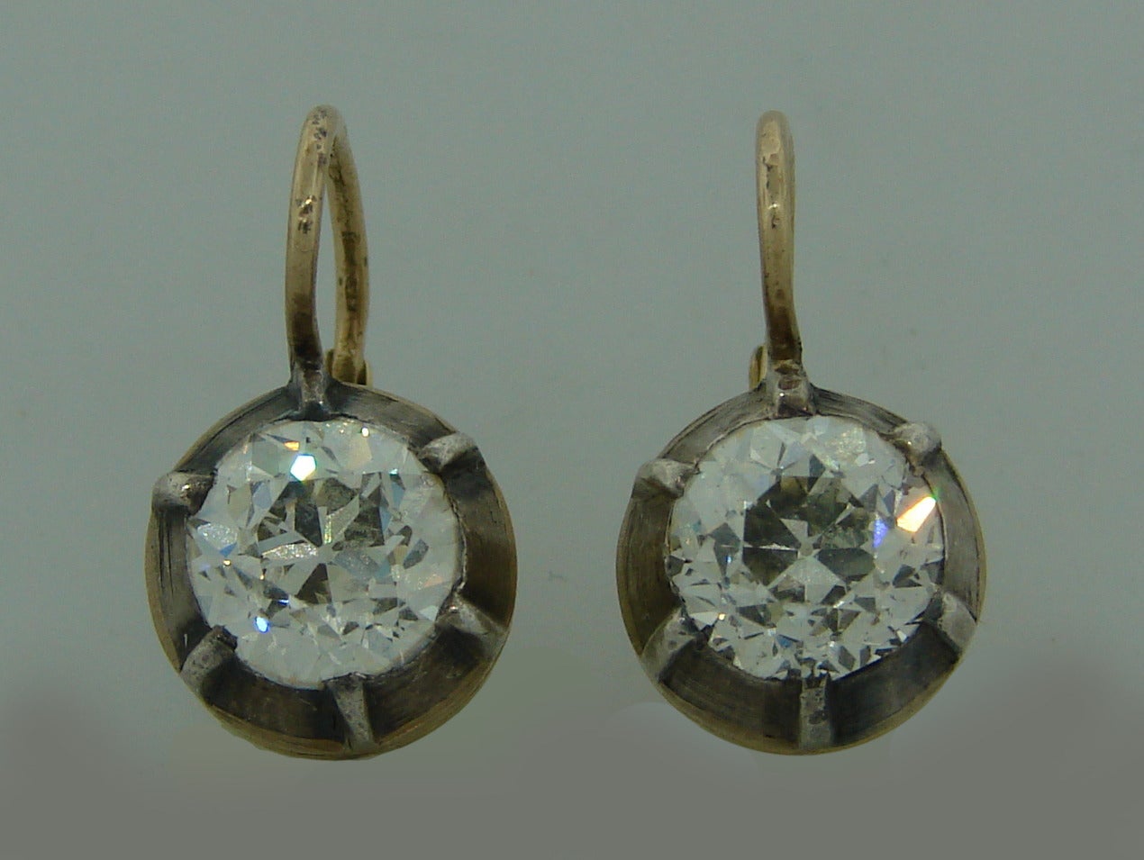 Gorgeous Victorian drop earrings featuring two Old European cut diamonds approximately 1.45 carat each. The diamonds are set in silver and 14k (tested) yellow gold. The diamonds are G color and VS2/SI1 clarity according GIA diamond grading system.