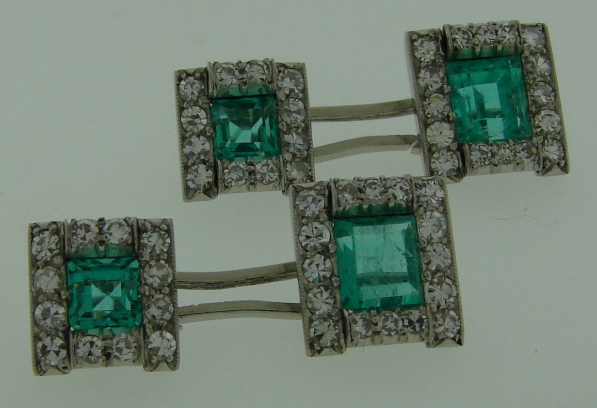 A pair of classy and timeless cufflinks. Created in the 1910's.  Made of platinum (tested) and set with four emeralds and sixty four diamonds. The emeralds are natural, emerald cut, total weight approximately 3.54 carats. The diamonds are single