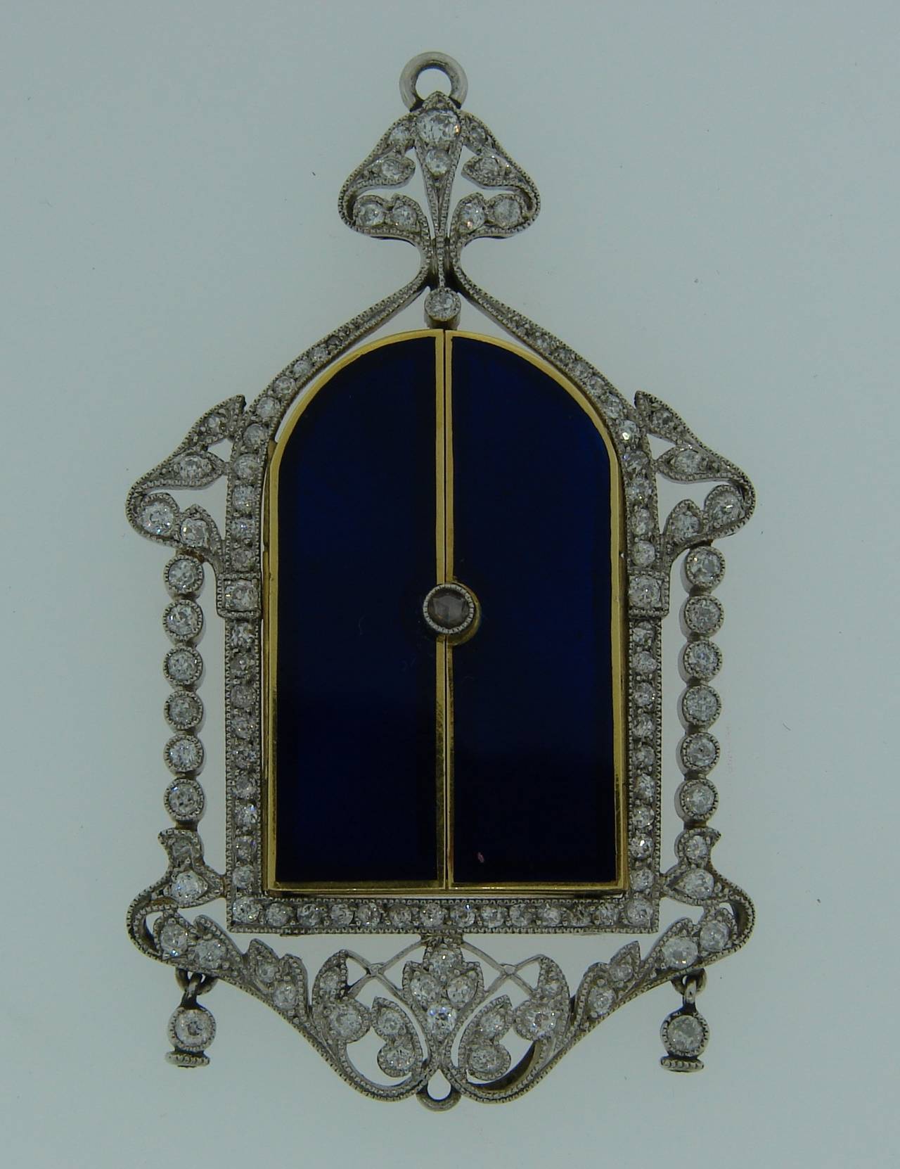 A unique piece of jewelry - a pendant / icon. An icon with two shutters that opens up and reveal a hand-painted Madonna. The icon is embedded in a delicate diamond & platinum frame. The icon is made of yellow gold and multi-colored enamel, the