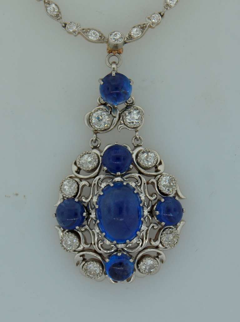 Stunning Art Nouveau sapphire & diamond pendant created by Tiffany & Co. in the 1930's. It features six cabochon sapphires and ten old mine cut diamonds set in 18k white gold. The chain part is set with Old European cut diamonds. The back of the