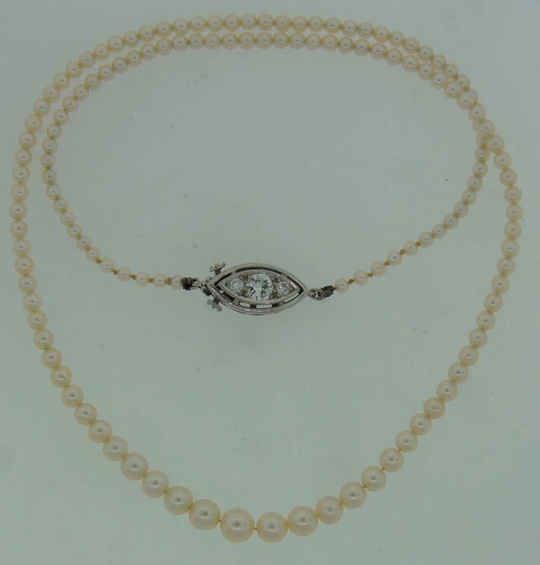 Delicate and feminine natural pearl necklace created by Tiffany & Co. in the 1940's. Features one hundred thirty nine round white pearls culminating in a diamond and platinum clasp. The pearls are natural salt water and are graduating from 4.65 to