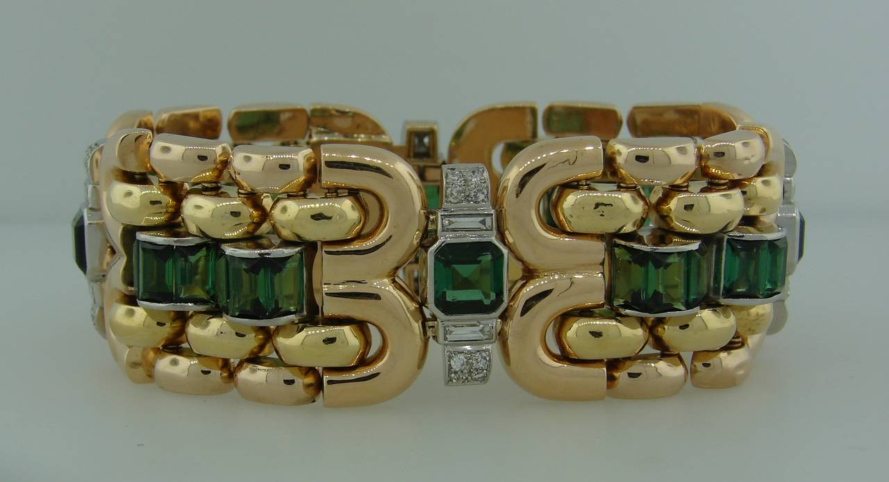 Elegant colorful Retro bracelet created in the 1940s. The bracelet is made of 18k yellow gold and platinum. Features twenty eight gorgeous step cut square and rectangular green tourmalines accented with single cut and baguette cut diamonds.