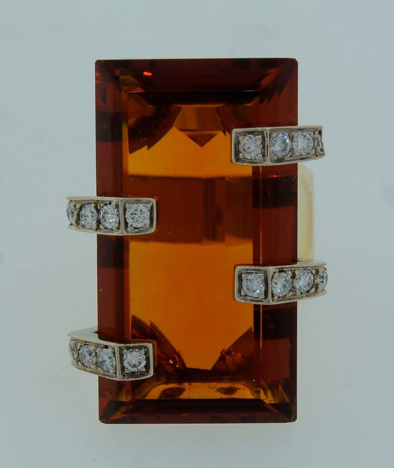 Big, bold and colorful ring created in Italy in the 1970's. Features a 54-ct rectangular citrine set in 18k yellow gold and accented with diamonds. The ring is size 8.25. The citrine measures 39.8 x 19.75 x 9.79 mm. 

The ring is 1-7/16