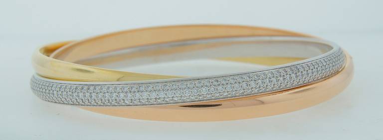 Classic signature Cartier three-tone Trinity bracelet with diamond paved white gold one. Size medium, inner diameter is 2.5