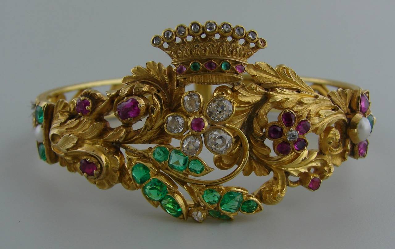 Unique Victorian bangle that was created in the end of 1800's as a mourning bracelet as it features a braided hair sections. The bangle has a wonderful floral design with a beautiful crown on top. There are nine diamonds on the crown. The number of