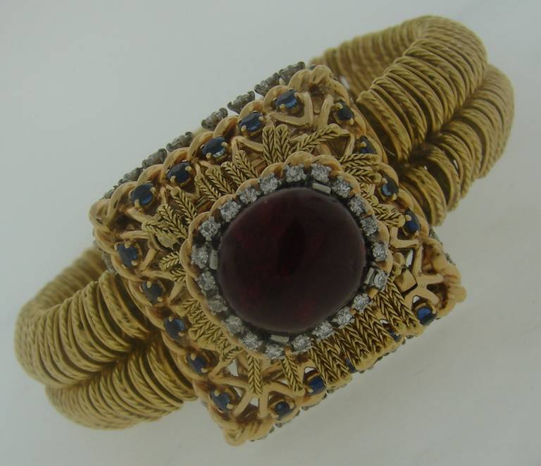 Chic and elaborate Retro bracelet watch with concealed dial, created by Pierre Sterle in Paris in the 1940s. Outstanding meticulous work on gold, majestic pyramid-shape, tasteful combination of gem stones are the highlights of this magnificent