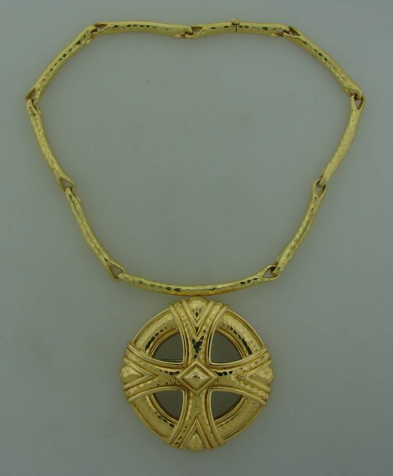 Bold yet elegant necklace created by Andrew Clunn in the 1980's. Perfect proportions, tasteful hand hammering on gold, sharp design - are the highlights of this prominent piece of jewelry. The pendant is detachable and can be worn separately as well
