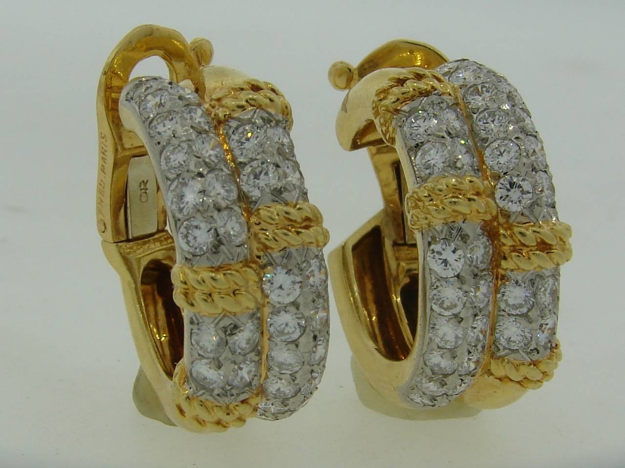 Classy and timeless diamond and yellow gold hoop earrings created by Fred in Paris in the 1980's. The earrings are made of 18k yellow gold and platinum and set with 64 round brilliant cut diamonds - total weight 3.20 carats. 
The earrings are 5/16