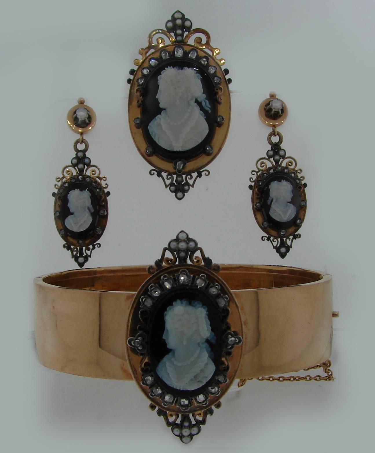 Stunning Victorian cameo set created on the turn of the 20th century in France. Consists of a bangle bracelet, a pair of earrings and a brooch / pendant. It comes in the original fitted box!

The set is made of 18k (hallmarked) yellow gold and
