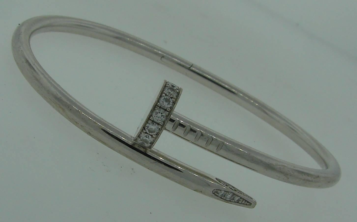 Signature Cartier Juste du Clou bangle bracelet. Made of 18k white gold and set with 27 bound brilliant cut diamonds of total weight 0.61 carat. Size 18.
Stamped with a Cartier maker's mark, hallmark for 18k gold, size and a serial number.
Retail
