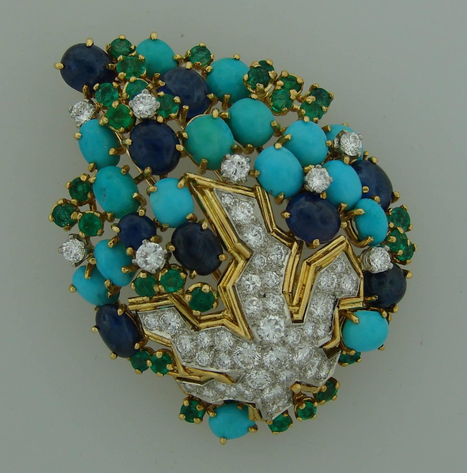 Chic and colorful brooch created in France in the 1970's. Made of 18k yellow gold and set with diamonds, turquoise, emeralds and sapphires. The diamonds are set in white gold which accentuates whiteness of the diamonds - thorough workmanship! The