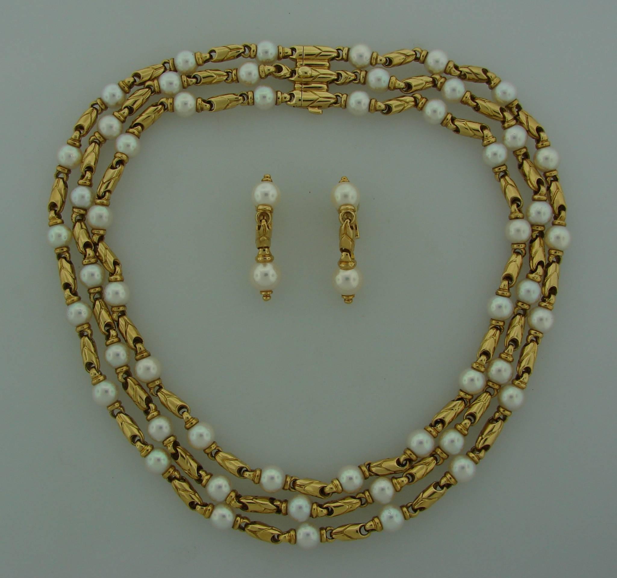 Gorgeous set consisting of a necklace and a pair of earrings created by Bulgari in Italy at the end of 1980's. Made of 18k yellow gold and features beautiful Akoya pearls. The pearls have lovely white color and beautiful luster. They measure in