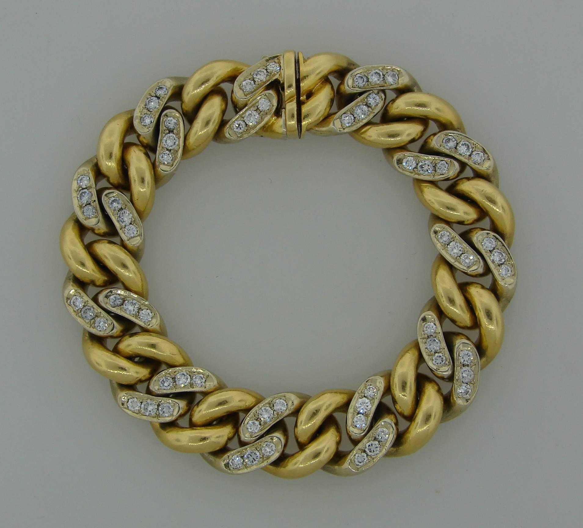 Nice and heavy link bracelet created by Cartier in Italy in the 1970's. Yellow gold links alternate with white gold links and the white gold links are encrusted with round brilliant cut diamonds (total weight approximately 2.40 carats). 
The