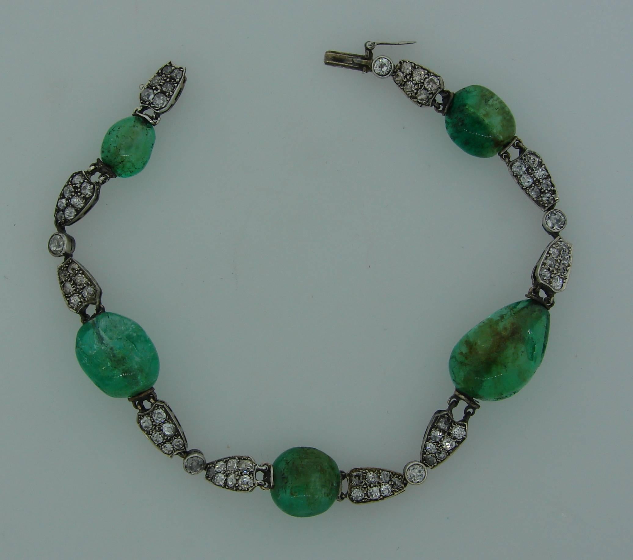 Lovely Art Deco bracelet created in the 1910's. Features five emerald beads alternating with knight shape links made of 18k (tested) white gold and set with old mine cut diamonds (total weight approximately 2.0 carats). 
The bracelet is 8