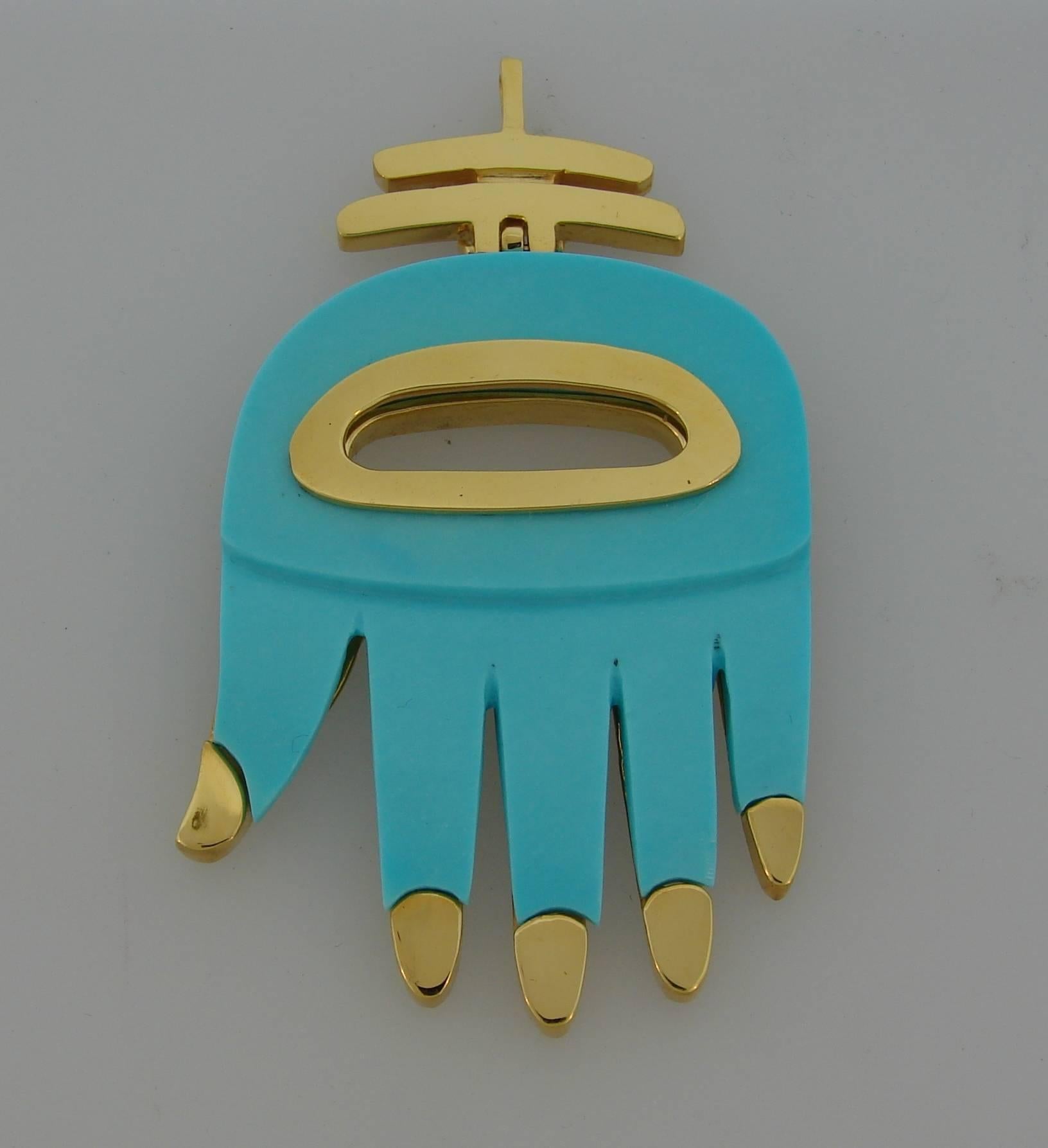 Colorful signature Aldo Cipullo Hamsa hand - a very recognizable and collectible piece of jewelry. Created in the 1970's. Made of 18k yellow gold and re-manufactured turquoise. 
Size L (large).
Measurements - height 2.5