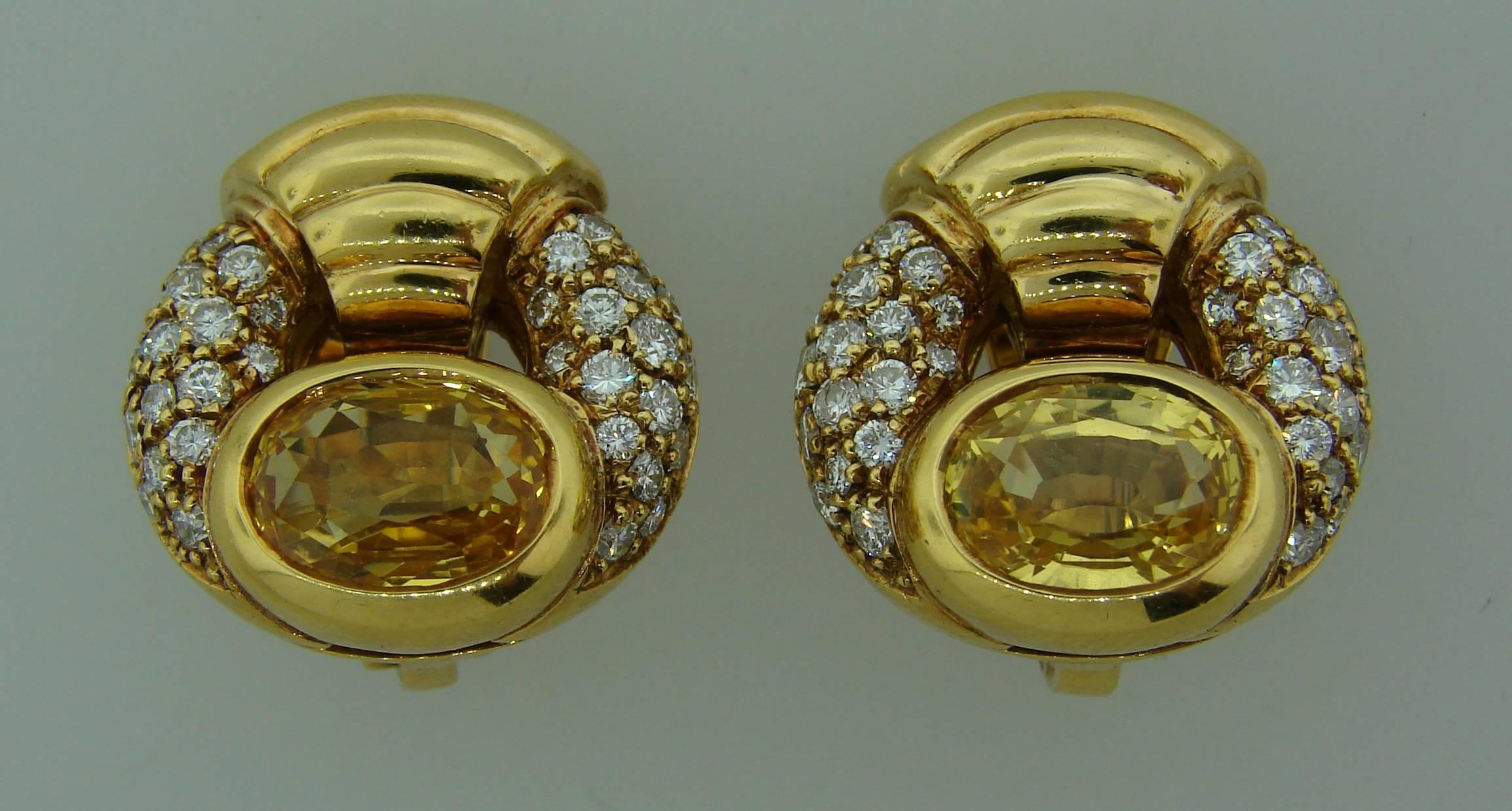 Elegant and stylish earrings created by Bulgari in the 1980's. Feature oval yellow sapphire set in 18k yellow gold and studded with round brilliant cut diamonds. Sapphires total weight is approximately 4.64 carats, diamond total weight is