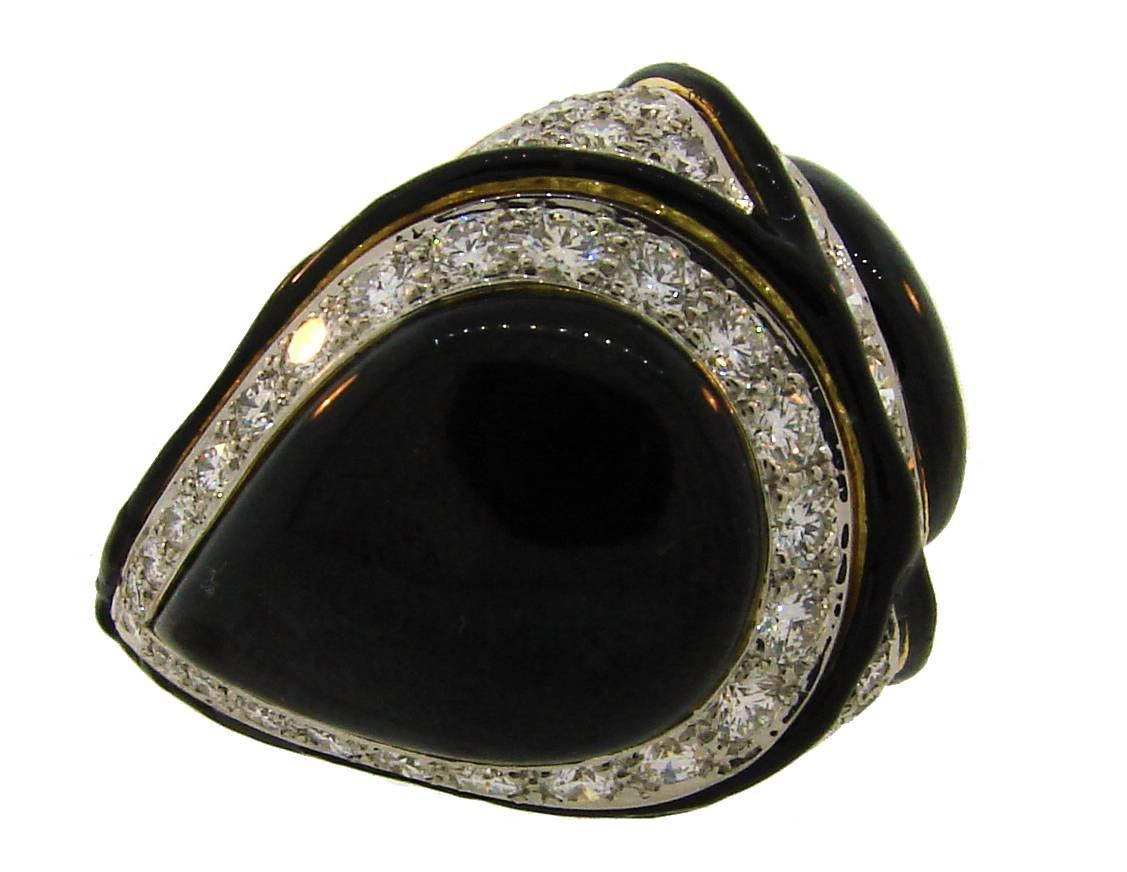 Stunning cocktail ring created by David Webb in the 1980's. It is made of 18 karat (stamped) yellow gold, black enamel and encrusted with round brilliant cut diamonds (total weight approximately 3.0 carats, F-G color, VS1 clarity). The diamonds are 