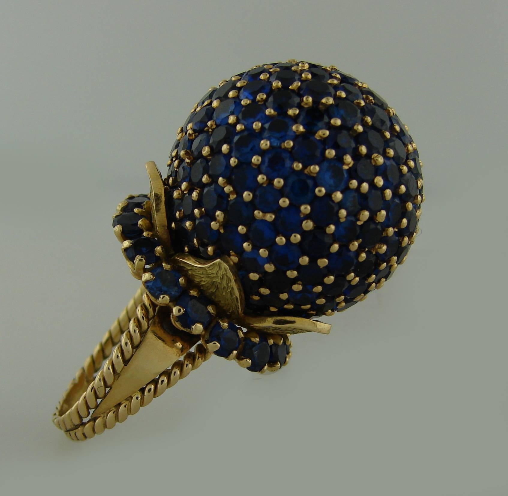 Stunning cocktail ring created in the 1970's. Definitely a conversational piece! Bold, chic, stylish and elegant, it is a great addition to your jewelry collection. 
It is made of 18 karat (tested) yellow gold and encrusted with round faceted