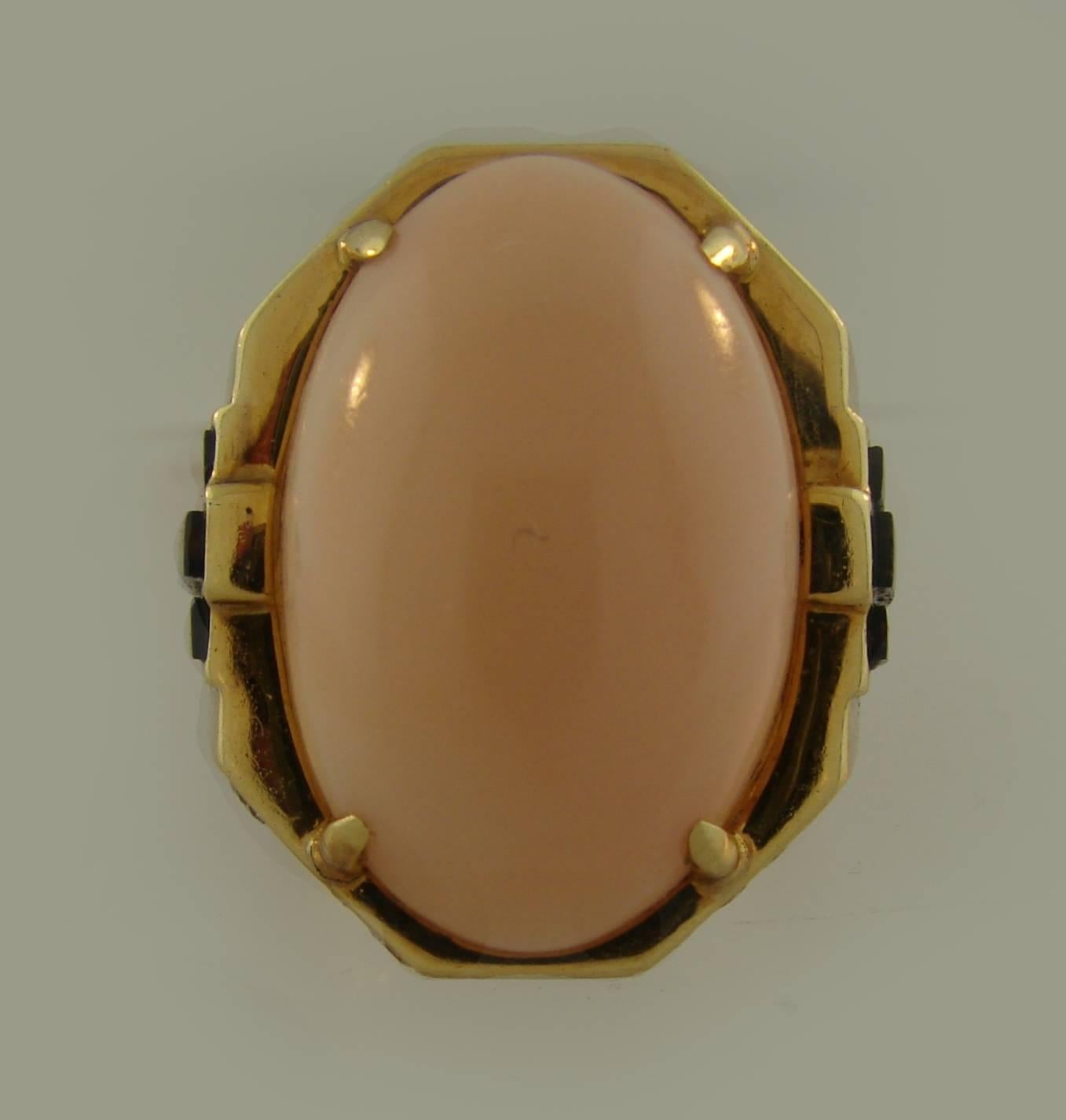 Bold yet elegant cocktail ring created by Bulgari in Italy in the 1970s. Features an oval cabochon angel skin coral set in yellow gold and accented with round brilliant cut diamonds and black enamel. Timeless, classy and wearable, the ring is a