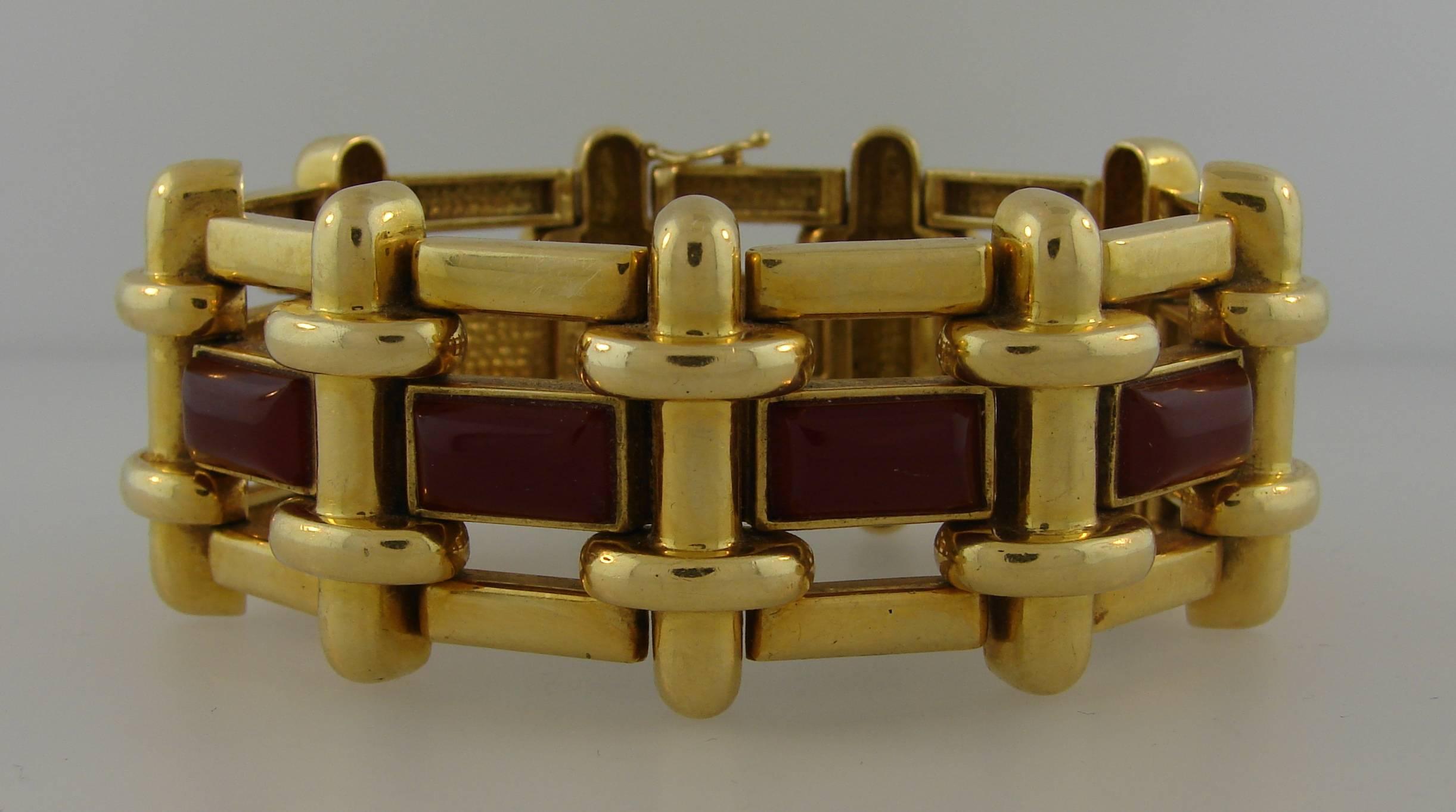 Bold architectural bracelet created by Aldo Cipullo for Cartier in the 1970s. Chic, wearable and collectable bracelet is a great addition to your jewelry collection. 
Made of 18 karat yellow gold and carnelian. 
The bracelet is 7 inches long and 1