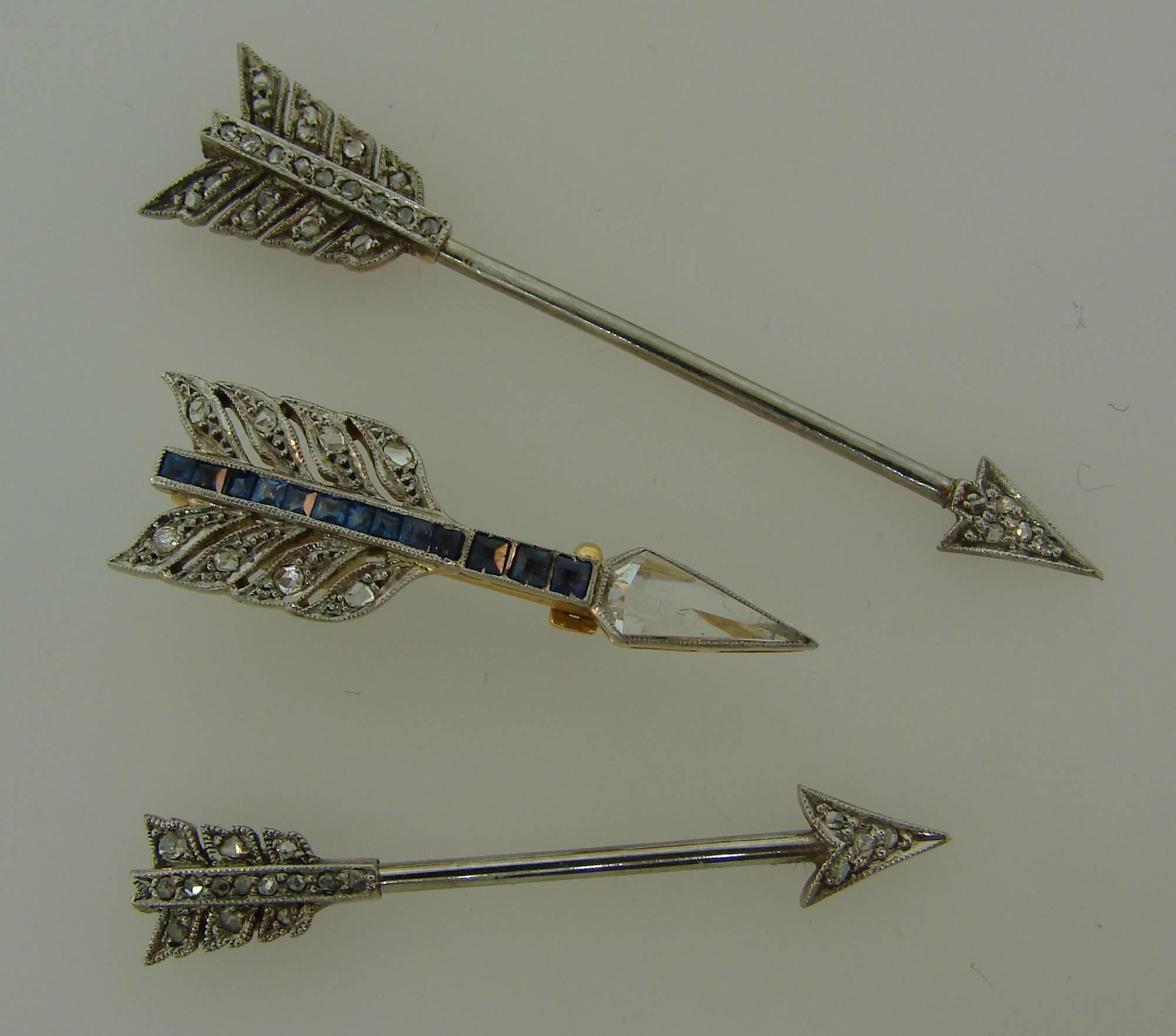 A trio of Art Deco arrow pins. Fun, versatile and wearable, the pins are a great addition to your jewelry collection. 
Made of platinum (tested) and 12 karat (tested) yellow gold and set with rose cut diamonds and sapphires. 
The largest pin