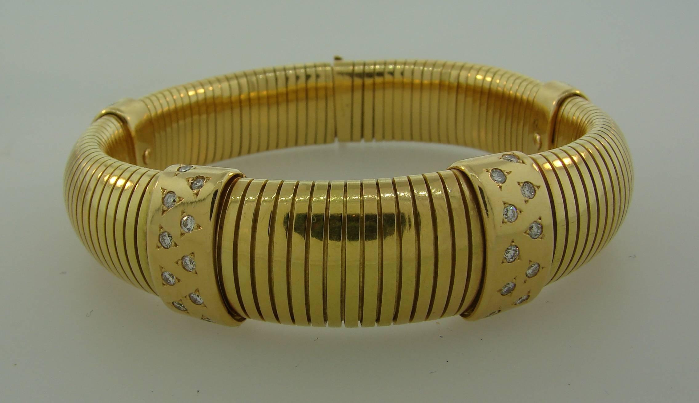 Elegant and timeless tubogas bracelet that is a great addition to your jewelry collection. Created by Cartier in Paris in the 1970's. Made of 18 karat yellow gold and accented with round brilliant cut diamonds (total weight approximately 0.80