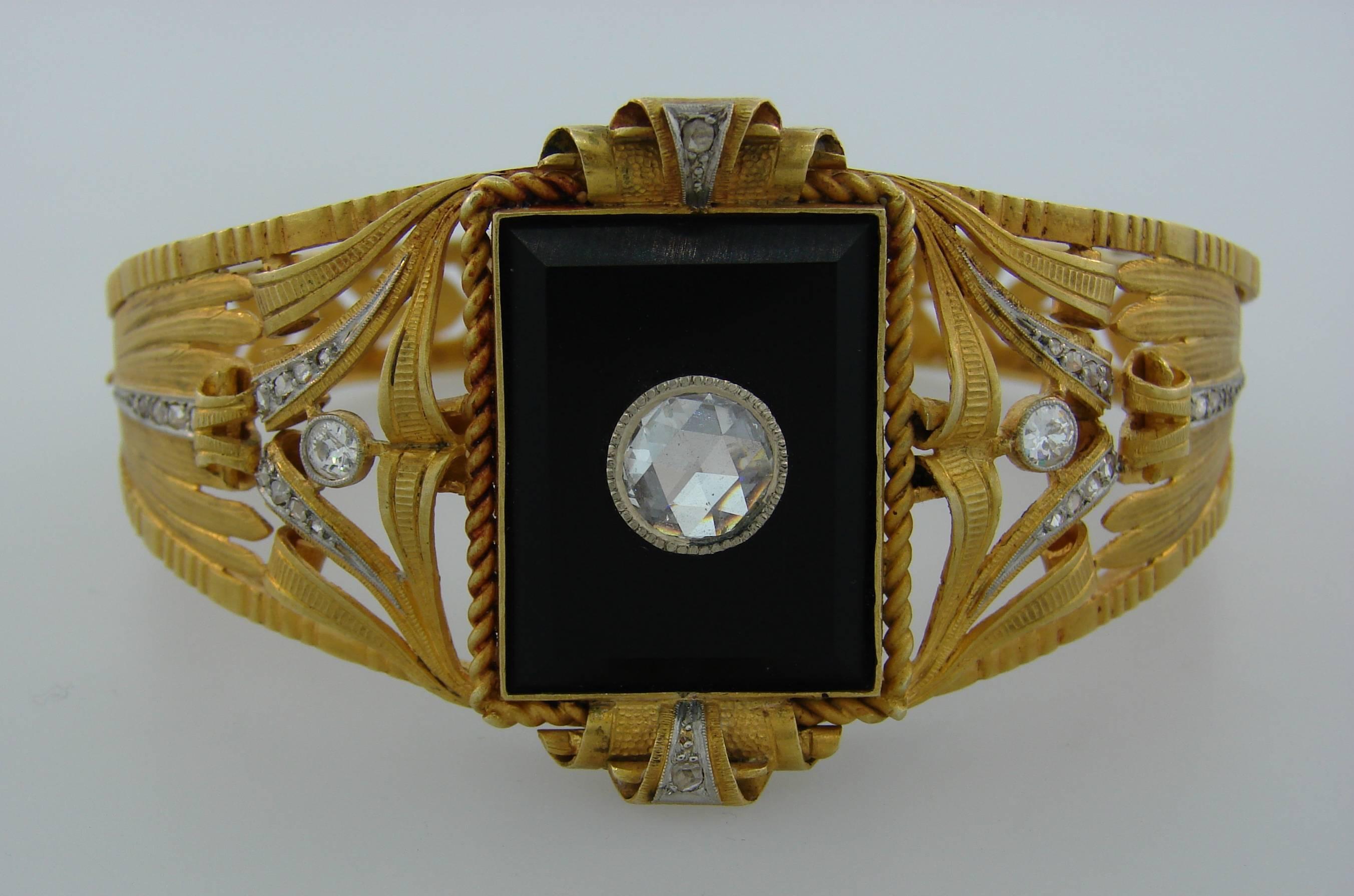 Gorgeous Victorian bangle bracelet. Unique and elegant, the bracelet is a great addition to your jewelry collection. 
It is made of 18 karat (tested) yellow gold and features a rectangular black onyx accented with a large rose cut diamond in the