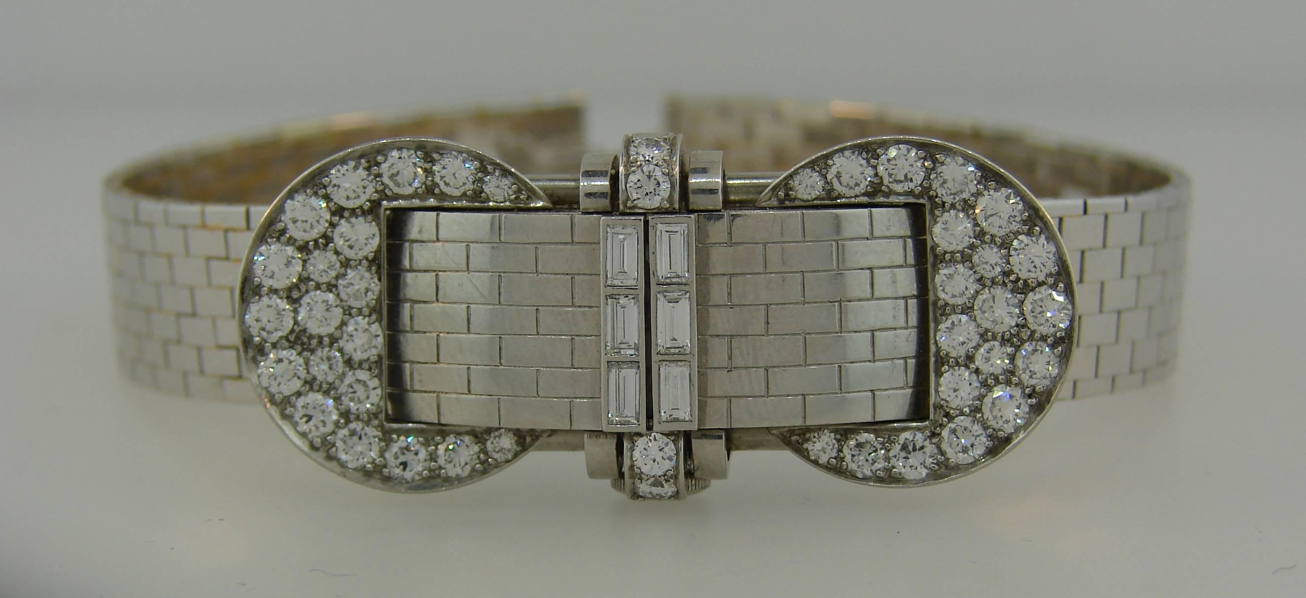 Elegant and feminine lady's watch bracelet created by Van Cleef & Arpels in New York in the 1940's. 
The watch case is made of platinum and set with transitional round full cut diamonds and baguette cut diamonds (F-G color, VS1 clarity, total