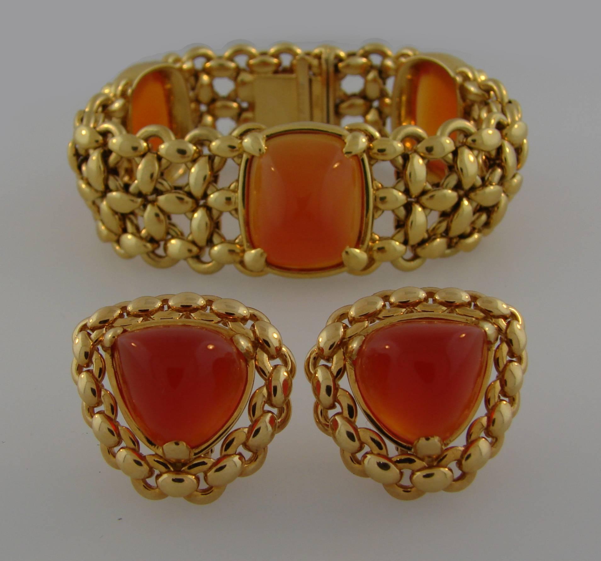 Beautiful classy set consisting of a bracelet and a pair of earrings created by Hermes in France in the 1980's. Elegant, organic and wearable, the set is a great addition to your jewelry collection. 
The color of the carnelian is closer than it