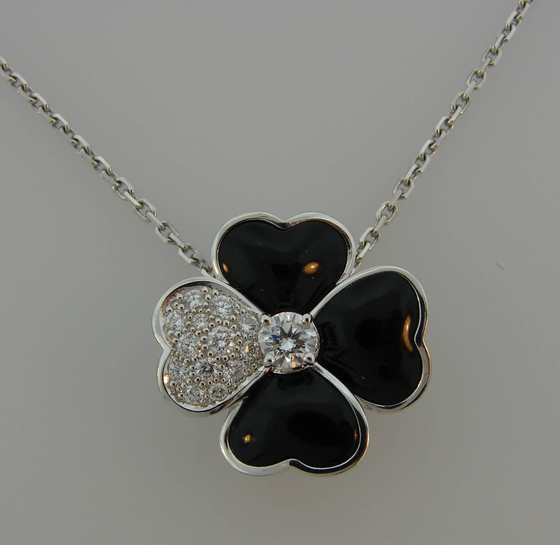 Signature Van Cleef & Arpels Cosmos pendant / necklace / clip / brooch. Composed of four heart-shaped petals, Cosmos is inspired by one of Van Cleef & Arpels' signature flowers, dating from the 1950s. Recognizable, wearable, chic,