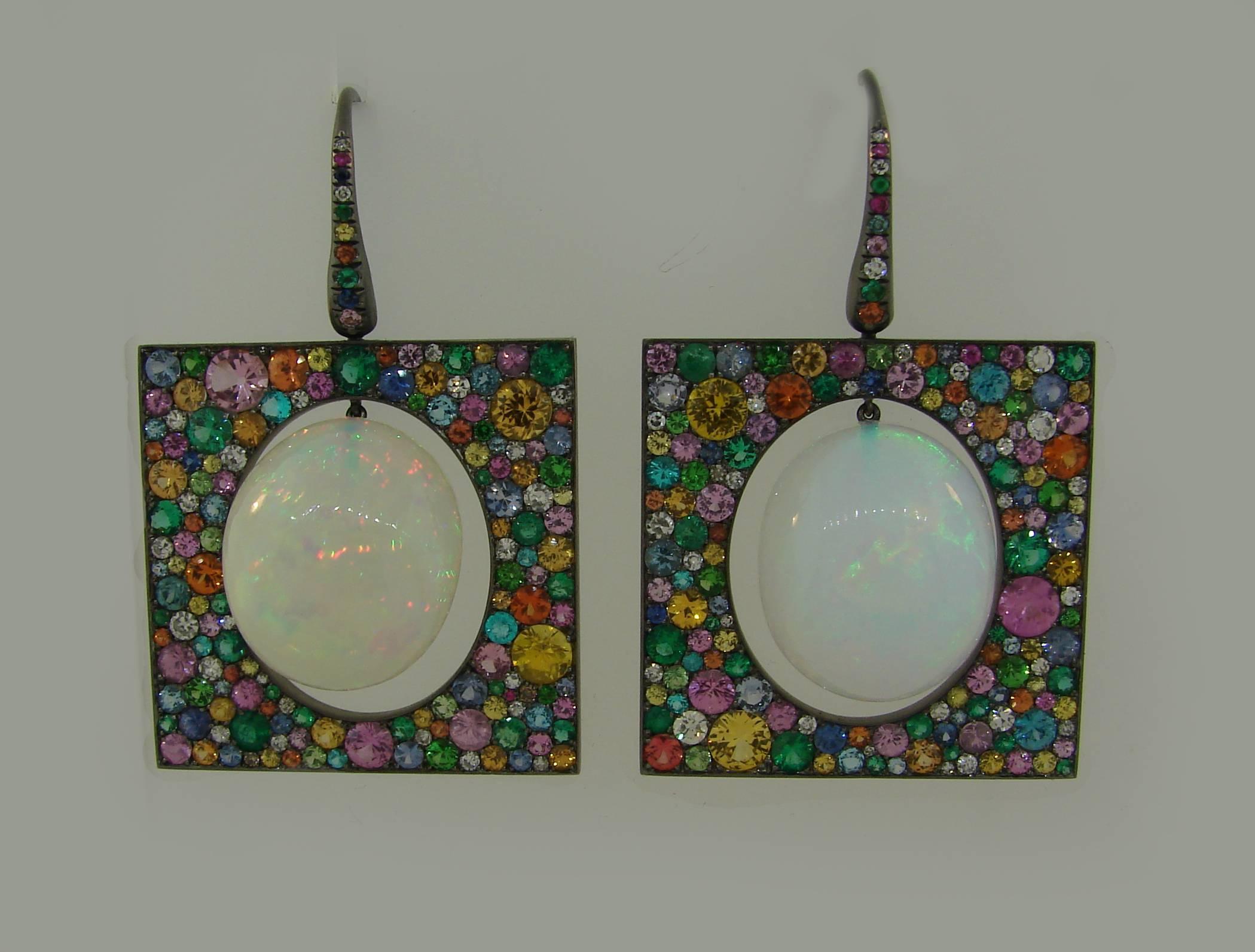 Colorful and unusual earrings created by a modern Greek designer Theodoros.  Stylish, different and wearable, the earrings are a great addition to your jewelry collection.
Made of 18 karat blackened gold, the earrings feature two oval opals framed