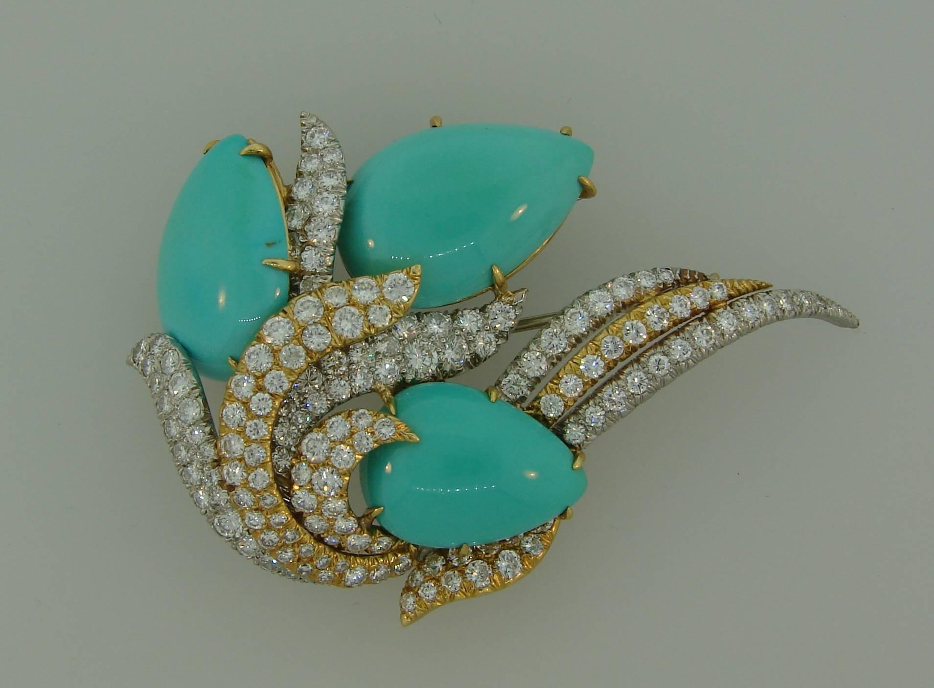 Stunning turquoise and diamond clip created by David Webb in the 1980s. It can also be worn as a pendant. Chic and elegant, the piece is a great addition to your jewelry collection. 
The brooch is made of platinum and 18 karat yellow gold, features