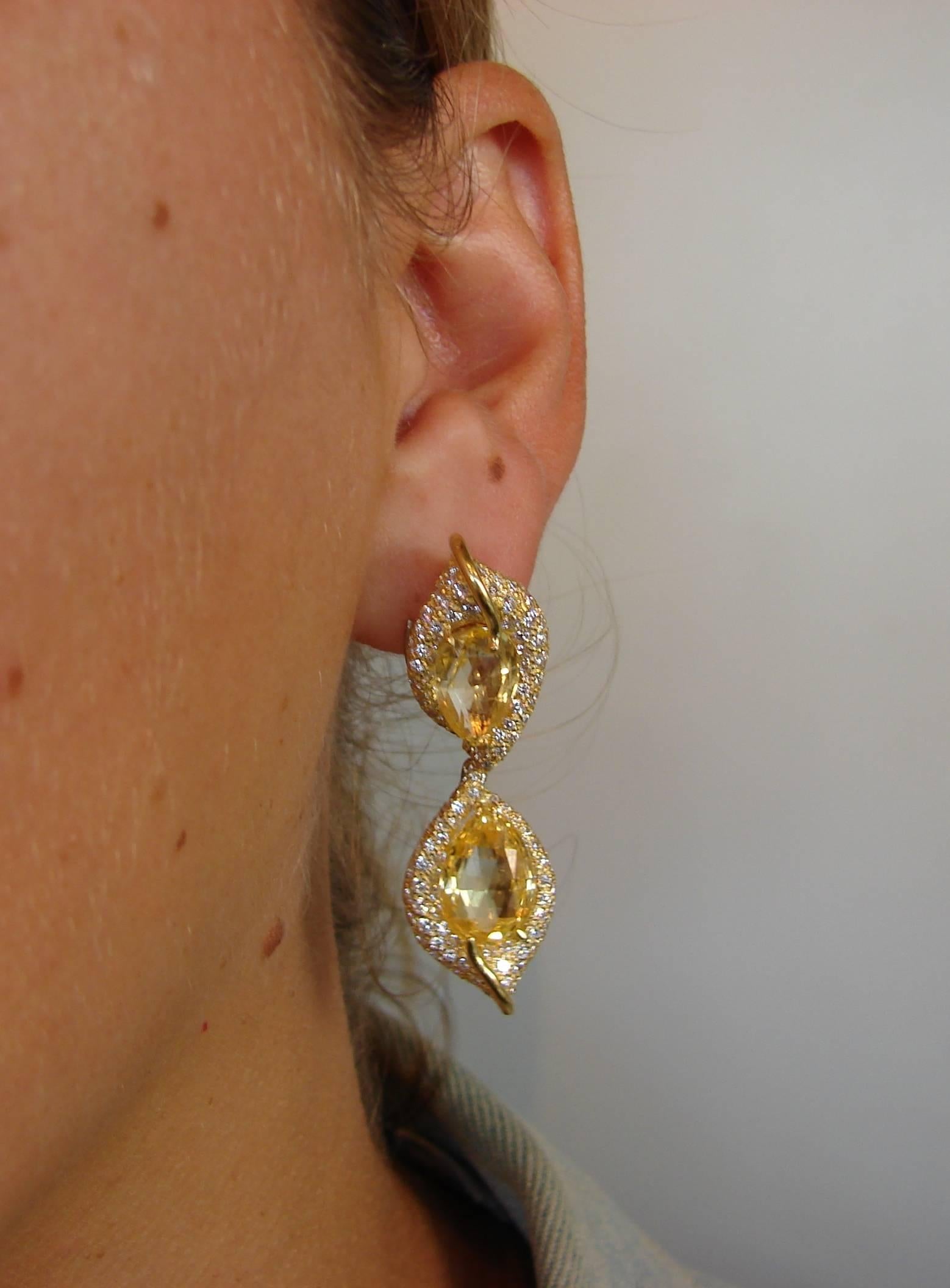 A pair of gorgeous earrings created by Henry Dunay in the 1980's. 
Made of 18 karat (stamped) yellow gold and feature four briolette cut yellow sapphires accented with round brilliant cut diamonds. The yellow sapphires total weight is approximately