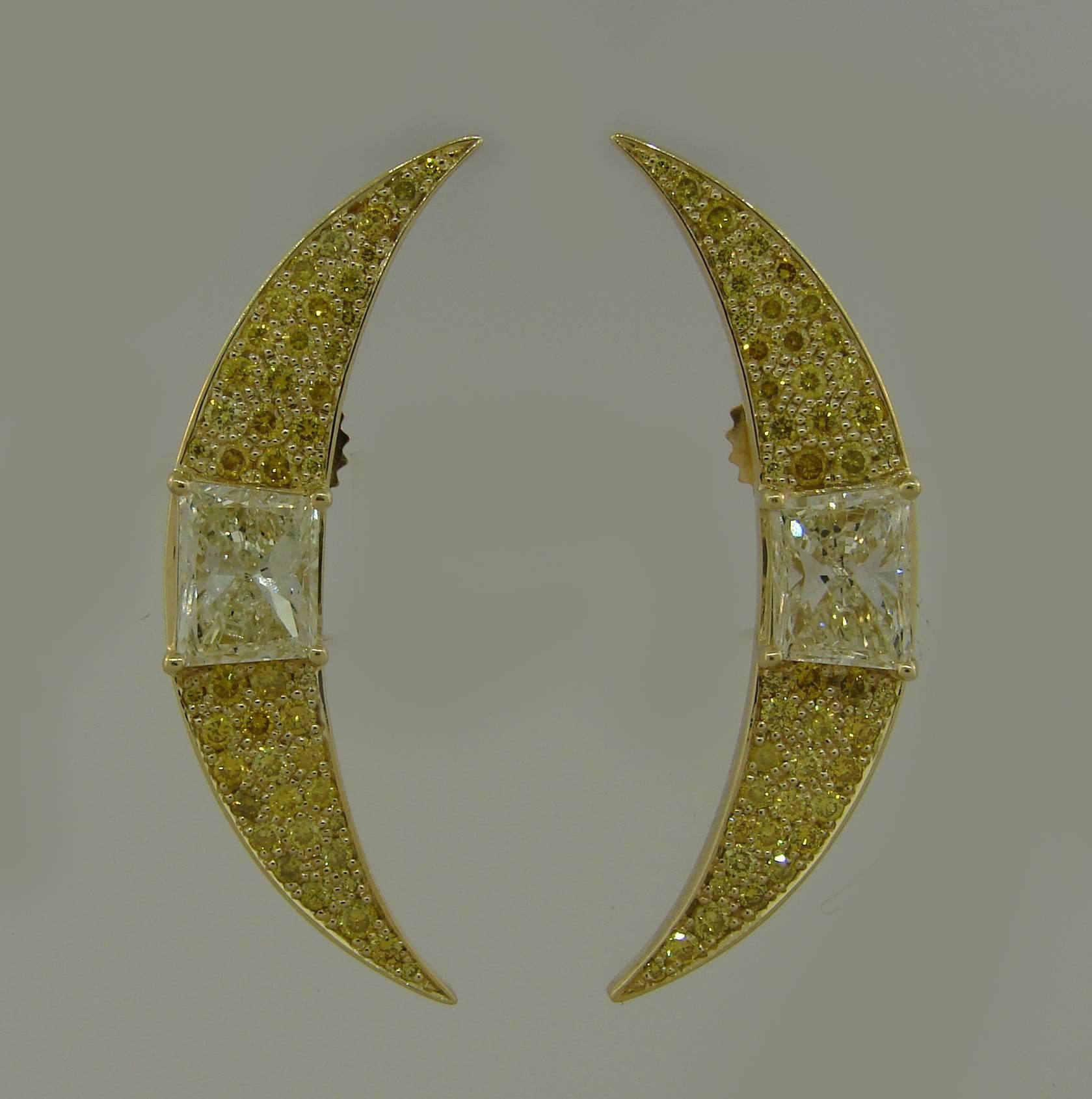 A pair of gorgeous crescent earrings. Chic and elegant, they are a great addition to your jewelry collection. 
Made of 17 karat (tested) yellow gold, the earrings feature two trapezoid shape light fancy yellow diamonds and round brilliant cut