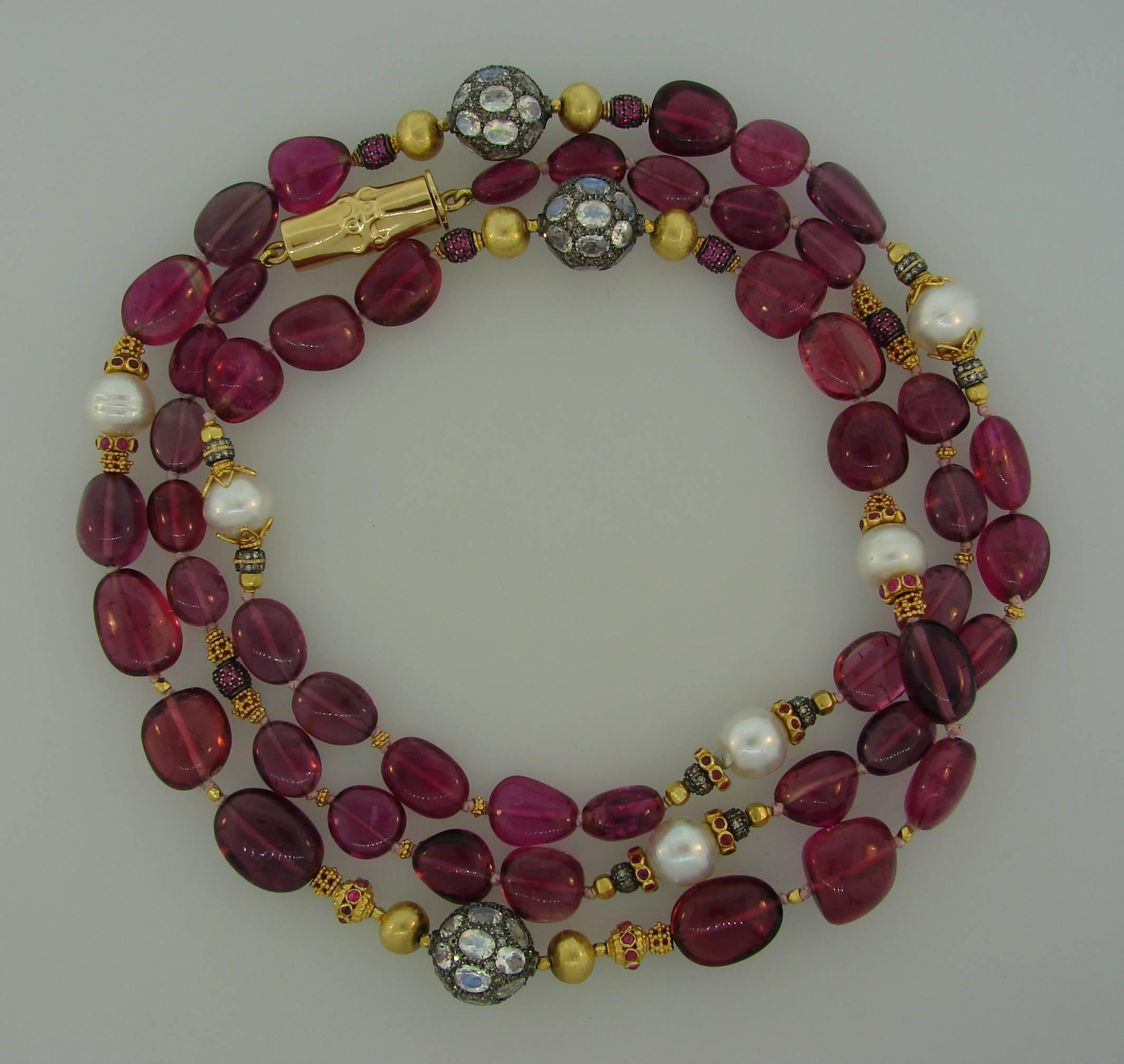 Lovely necklace created by Verdura in the 2000s. It is made of pink tourmaline beads, rubies, moonstone,  single cut diamonds, South Sea pearls, yellow gold beads, and silver. The Bamboo clasp is made of 18k yellow gold. Colorful, versatile and