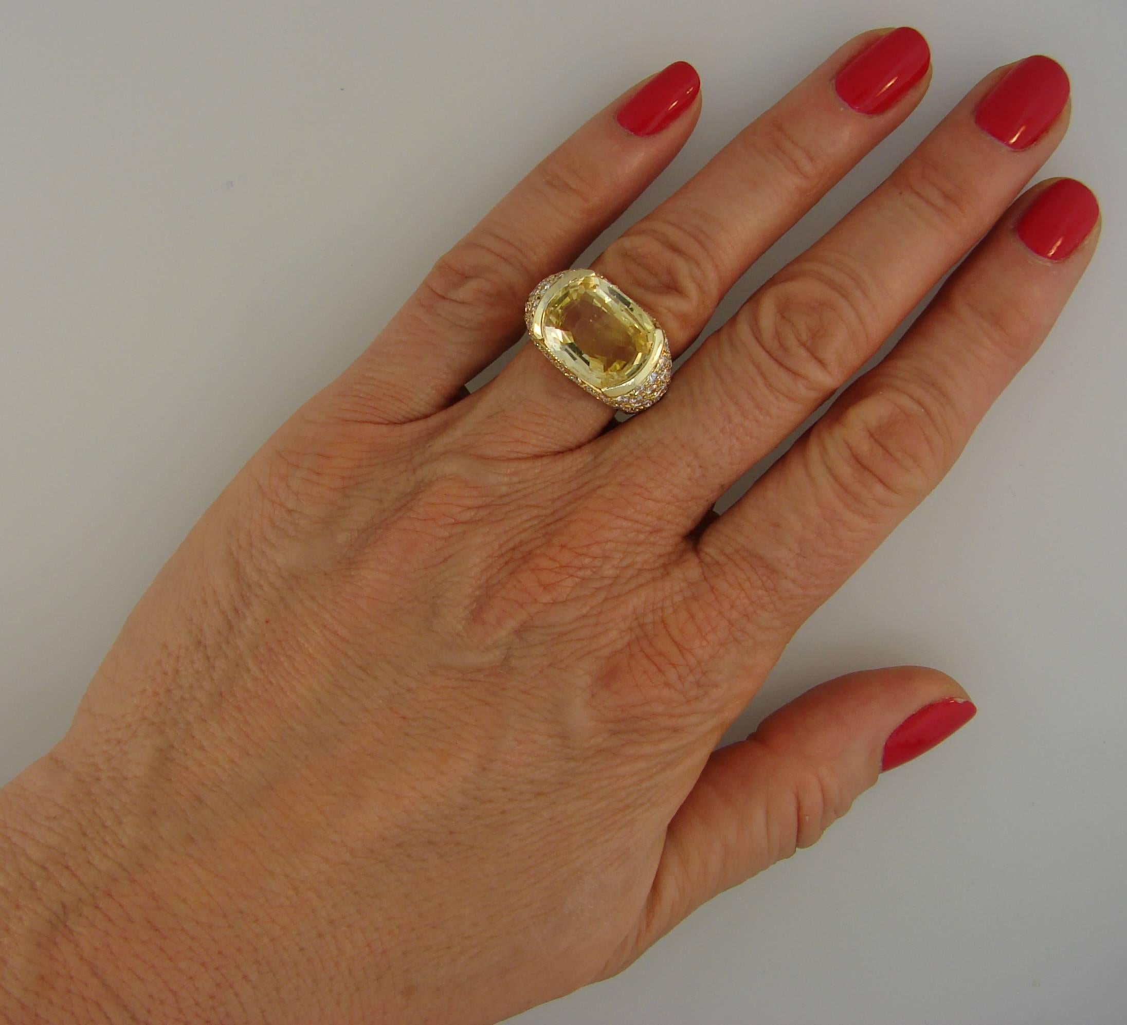 Magnificent cocktail ring created by Van Cleef & Arpels in New York in the 1980s. 
Elegant and classy, the ring is a great addition to your jewelry collection. 
Features an approximately 12-carat cushion cut yellow sapphire tastefully embedded in 18