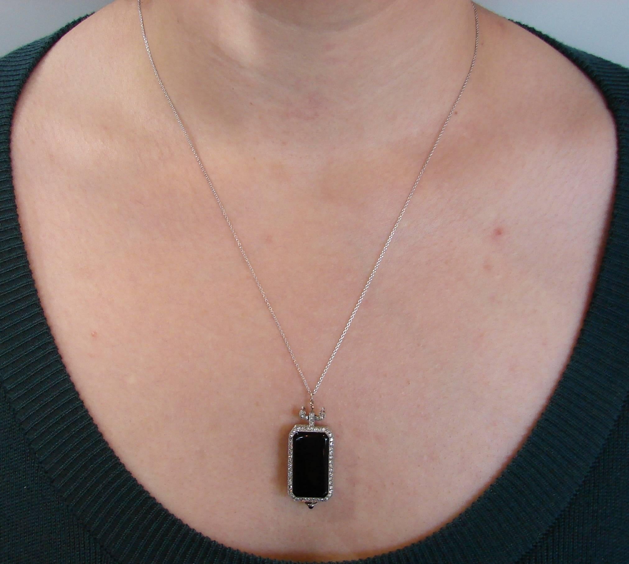 Classy Art Deco watch pendant created by Dreicer & Co. in the 1910's. Made of platinum and black onyx and accented with single cut diamonds (total weight approximately 0.40 carat) on a platinum chain. The chain was added later.
The watch is