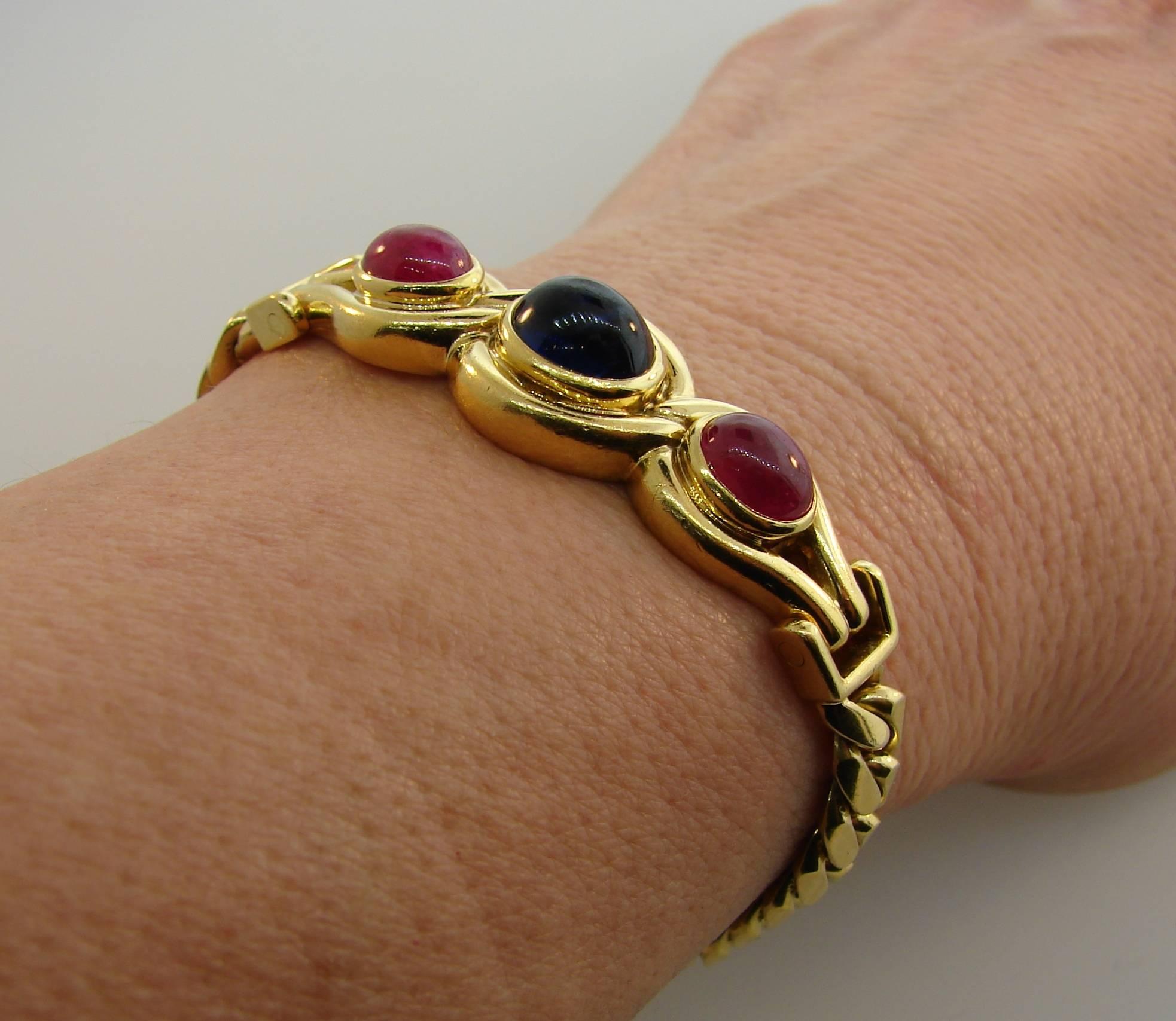 Bold yet elegant bracelet created by Bulgari in Italy in the 1980s. Chic and wearable, it is a great addition to your jewelry collection. 
The bracelet is made of 18 karat yellow gold and set with an oval cabochon sapphire and two oval cabochon