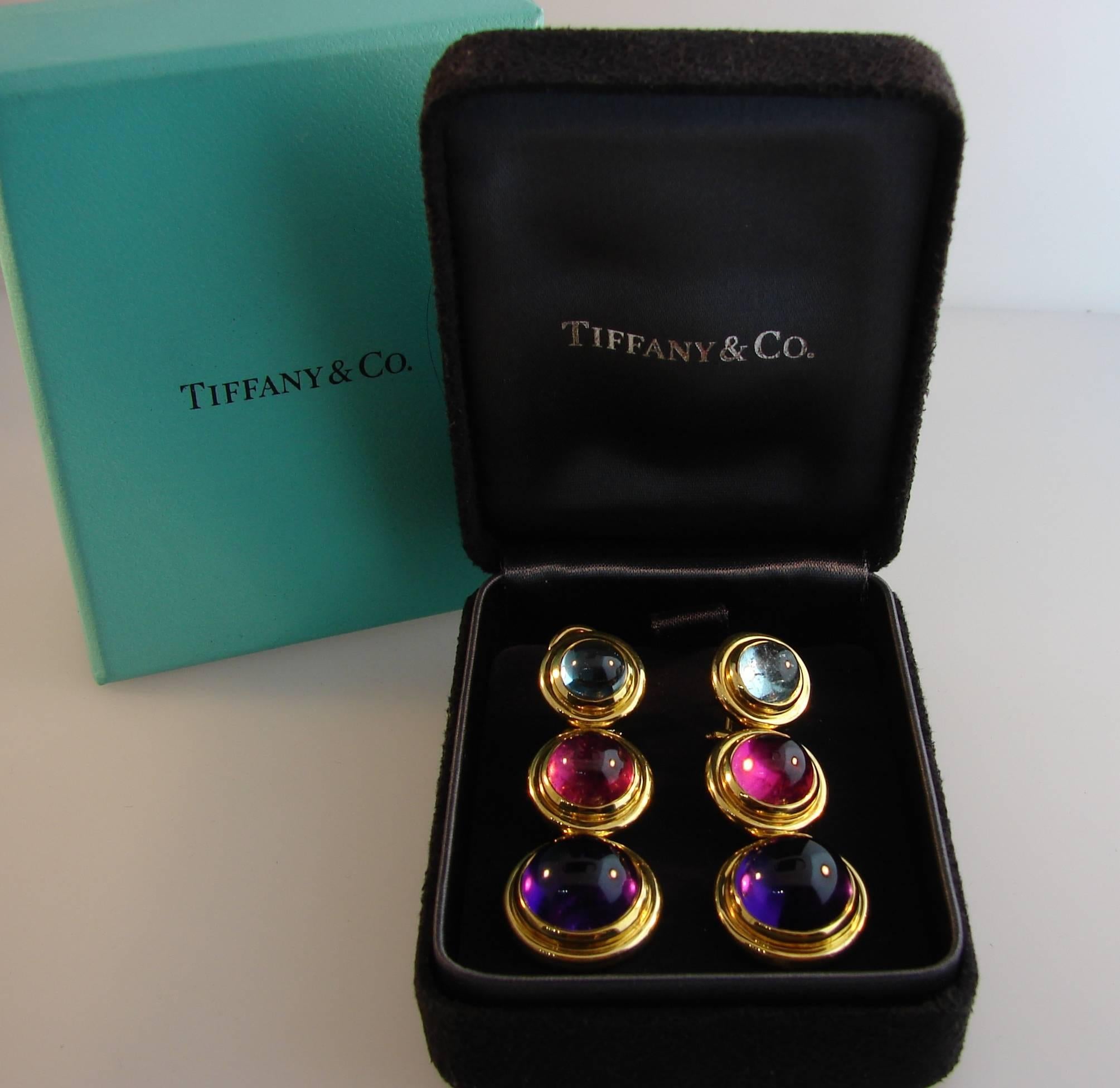 Chic colorful earrings created by Paloma Picasso for Tiffany & Co. Well proportioned, stylish and wearable, the earrings are a great addition to your jewelry collection. 
Made of 18k yellow gold and set with cabochon amethyst, aquamarine and